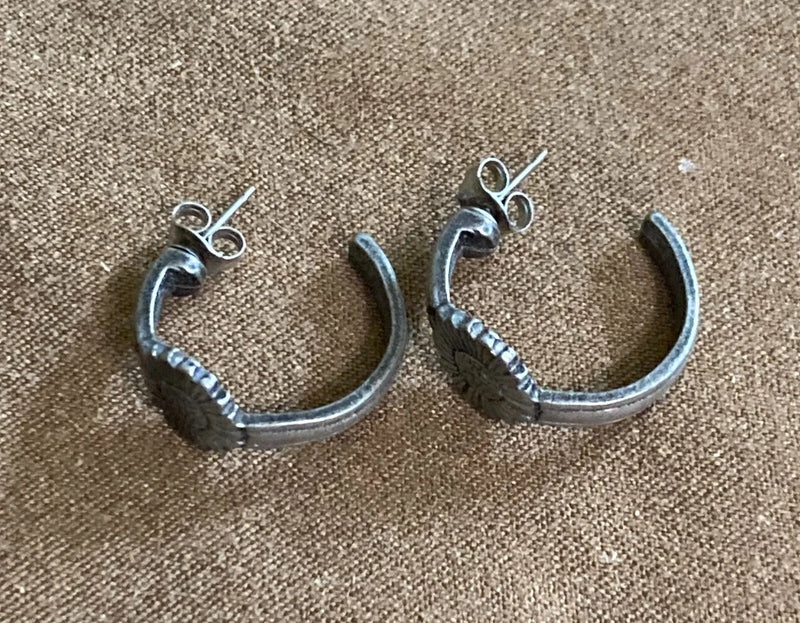 Silver-tone C-hoop earrings with sunflower charms and beaded detail along the curve