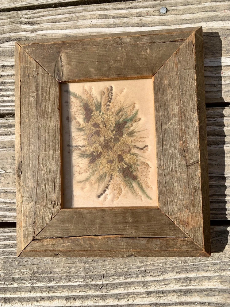 Vintage pressed flower wall decor in rustic wooden frame with beige dried flower print