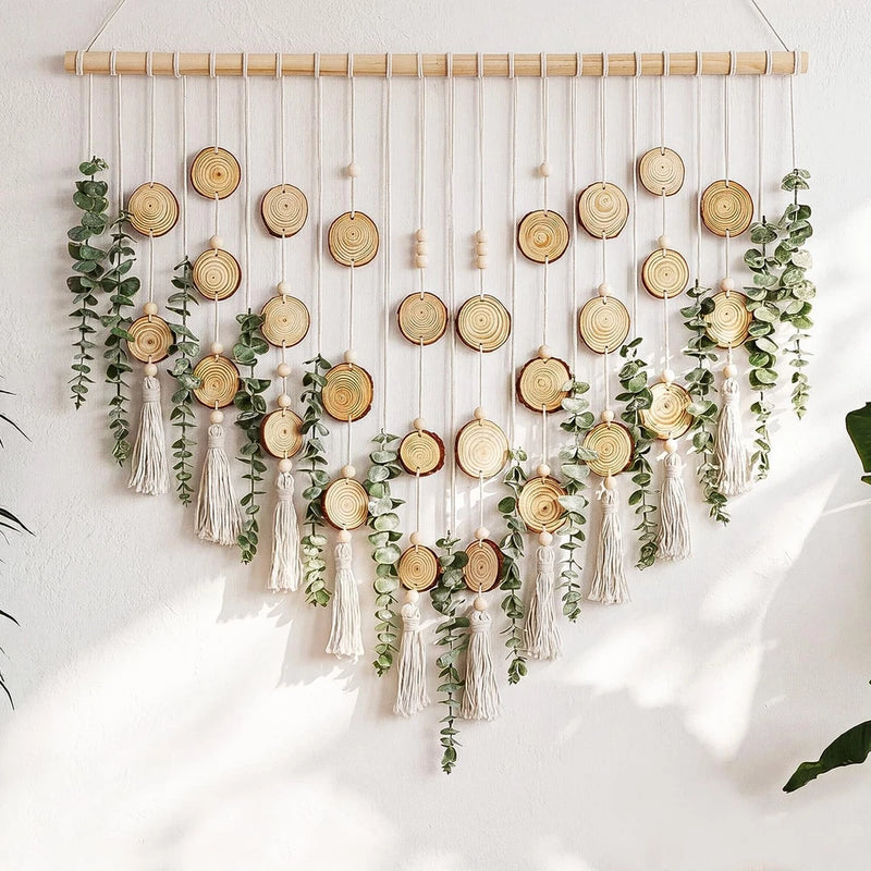 Artificial eucalyptus wall hanging with green foliage and round wooden slice ornaments