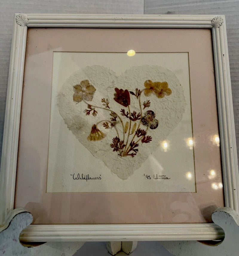 Wood-framed dried pressed flowers heart collage artwork with signature, viewed straight on