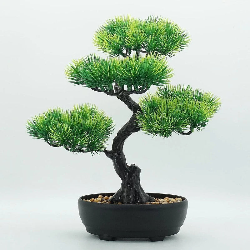 Artificial bonsai tree with green foliage in a dark rectangular pot with pebbles