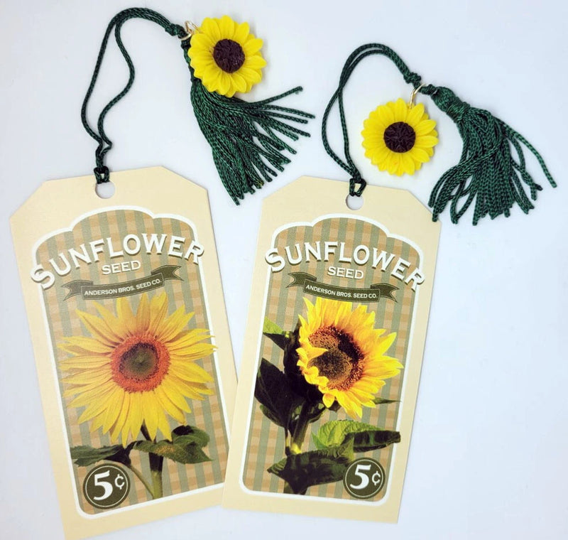 Set of 2 sunflower seed bookmarks with yellow flower accents and dark green tassel cords