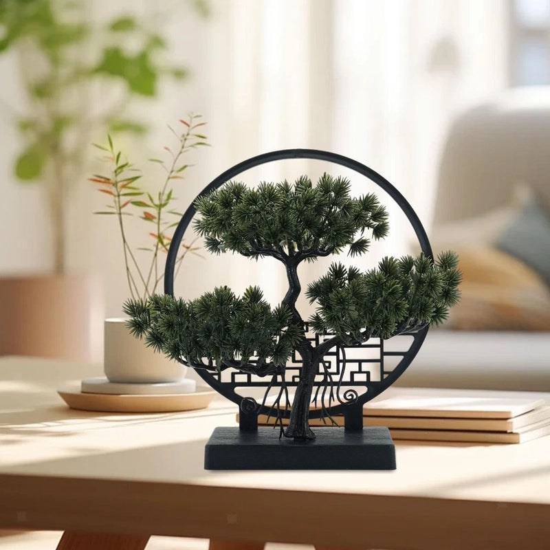 Artificial bonsai tree with dark pot and green needle-like leaves on black stand