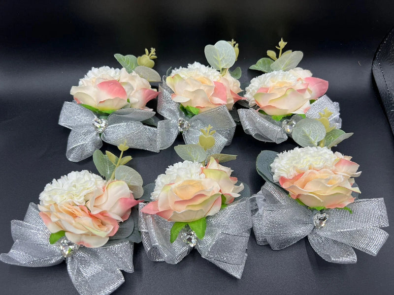 Floral wrist corsage with pastel roses, greenery, silver glitter bow and rhinestone charm