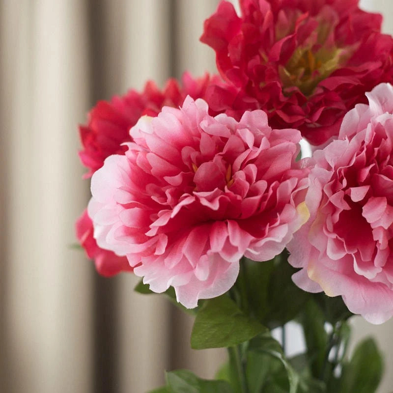 Artificial peony floral bush with pink and light pink blooms and green leaves