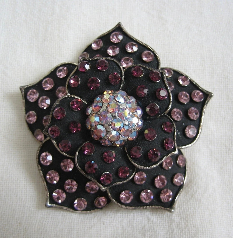 Floral rhinestone brooch pin with pink-purple stones and iridescent crystal center