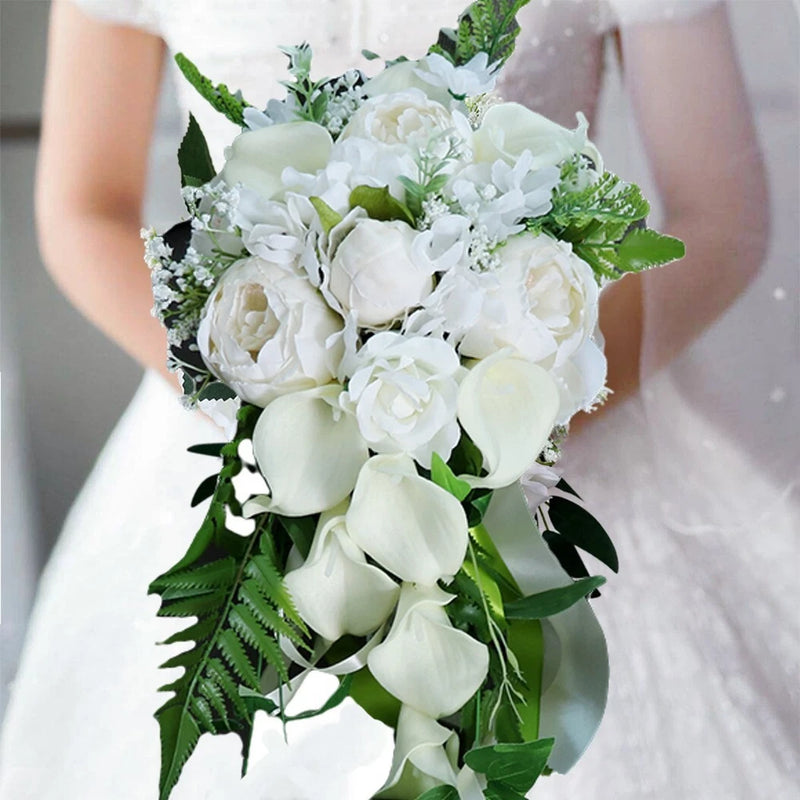 Artificial white calla lily and rose wedding bouquet with cascading fern leaves and greenery