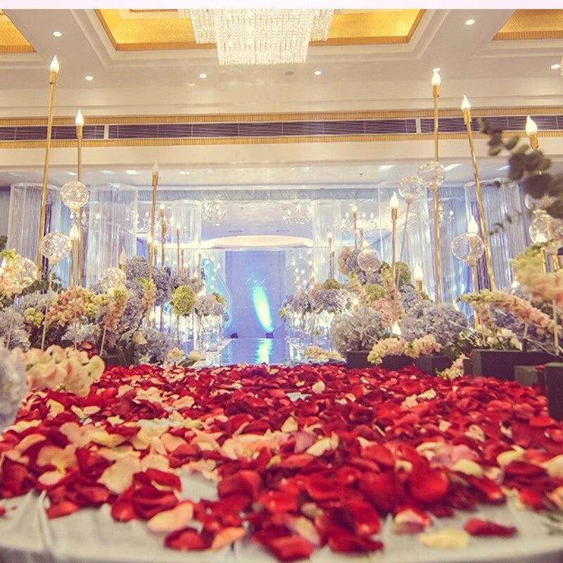 Artificial rose petals scattered in red and cream for wedding bed decor
