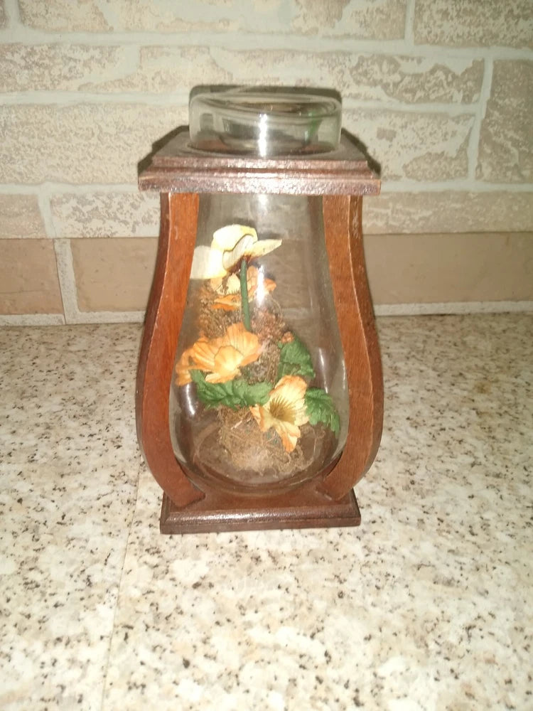 Wooden lantern-style glass display jar sealed with dried flowers