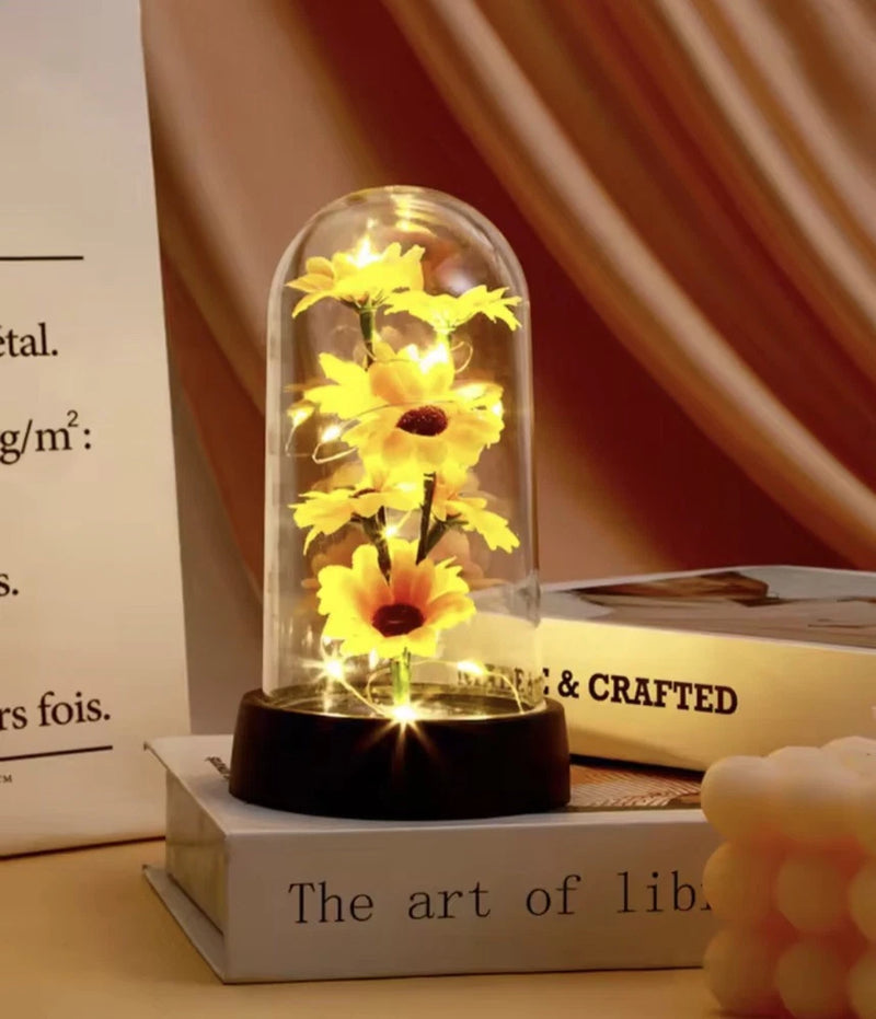 Small sunflower LED dome decor with yellow flowers under glass, on a black base