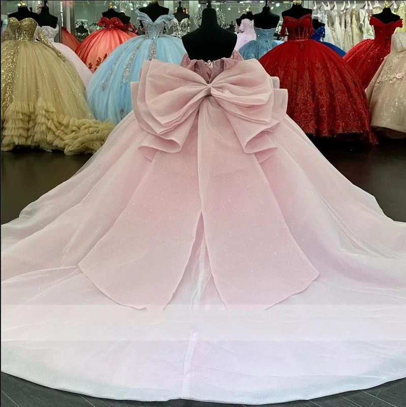 Blush pink quinceanera dress with oversized bow at the bodice