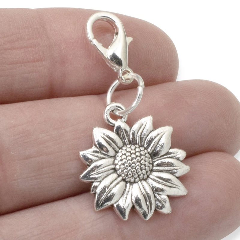 Silver sunflower clip-on bag charm with small loop and clasp, detailed petal design