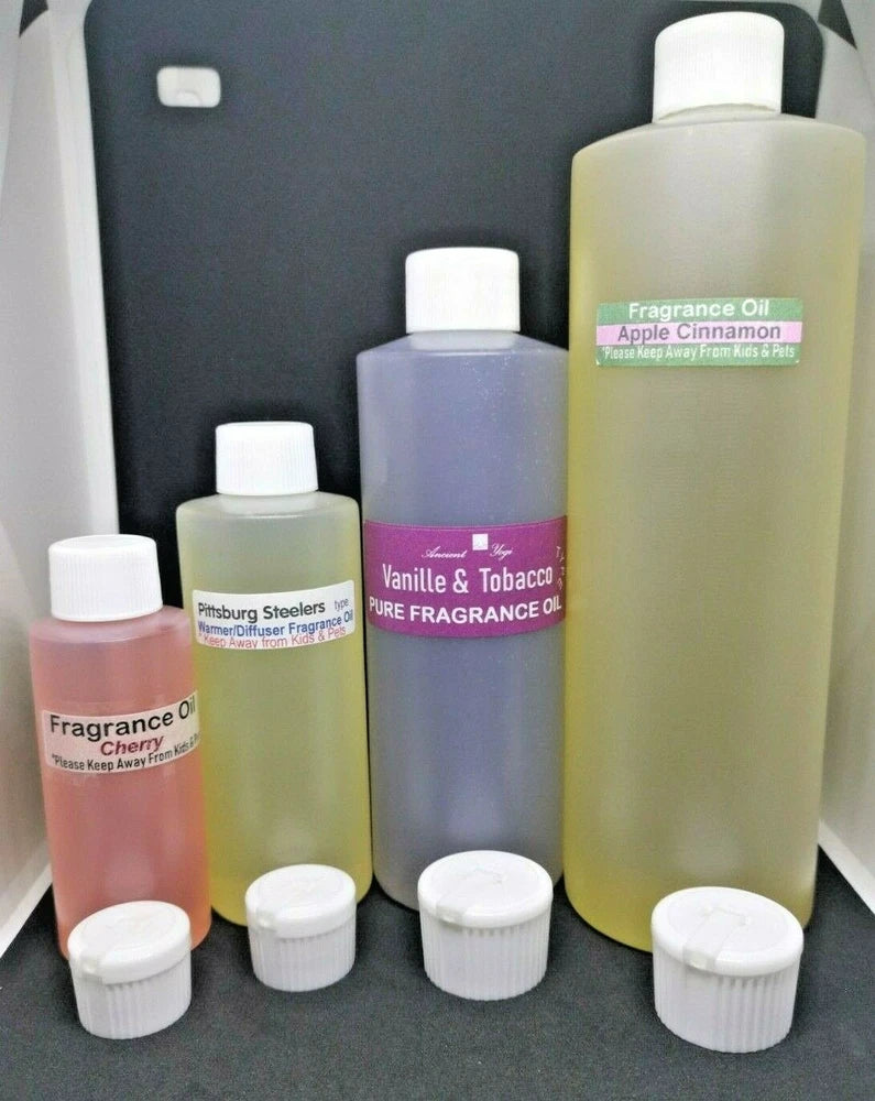 Scented fragrance oil bottles with white caps, featuring Vanilla & Tobacco and Apple Cinnamon labels