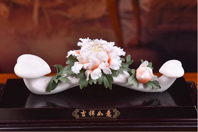 White porcelain auspicious peony centerpiece with carved flower petals and leafy branches