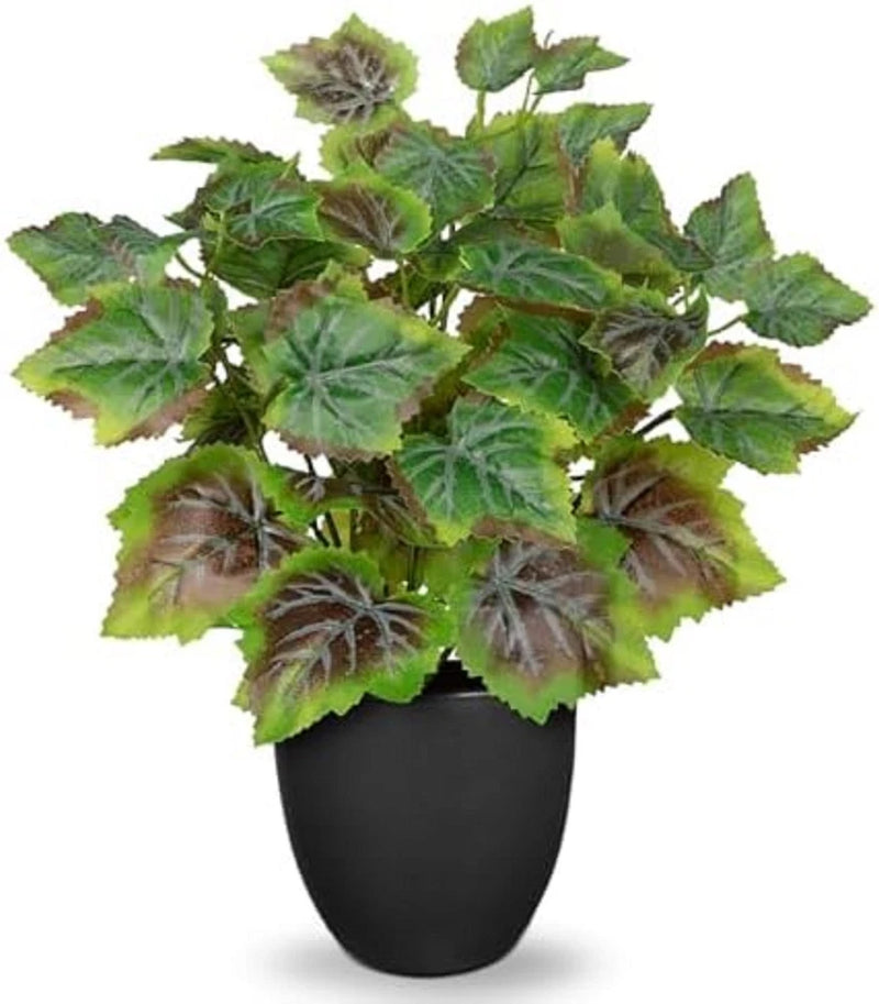 Artificial potted silk plant with green leafy stems in a black vase