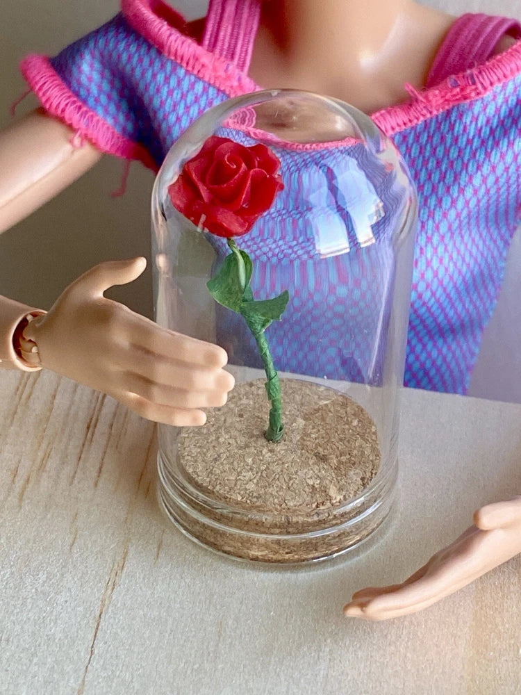 Miniature red rose in clear glass dome with textured base