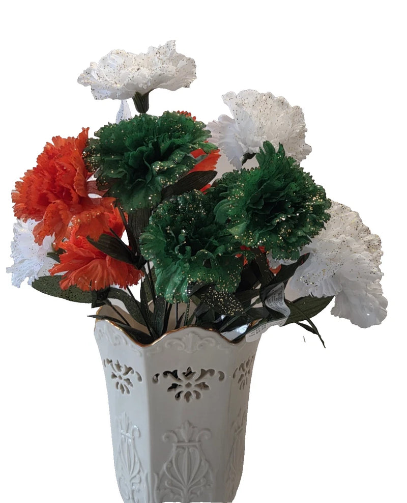 Artificial carnation bouquets in green, orange, and white with decorative white vase