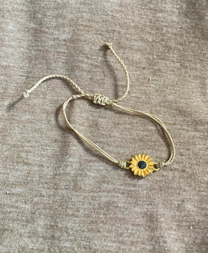 Tan cord bracelet with gold sunflower charm and adjustable slide closure