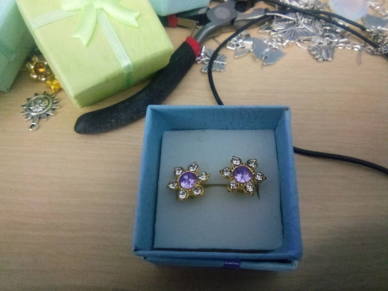 Sunflower rhinestone stud earrings with purple crystal centers