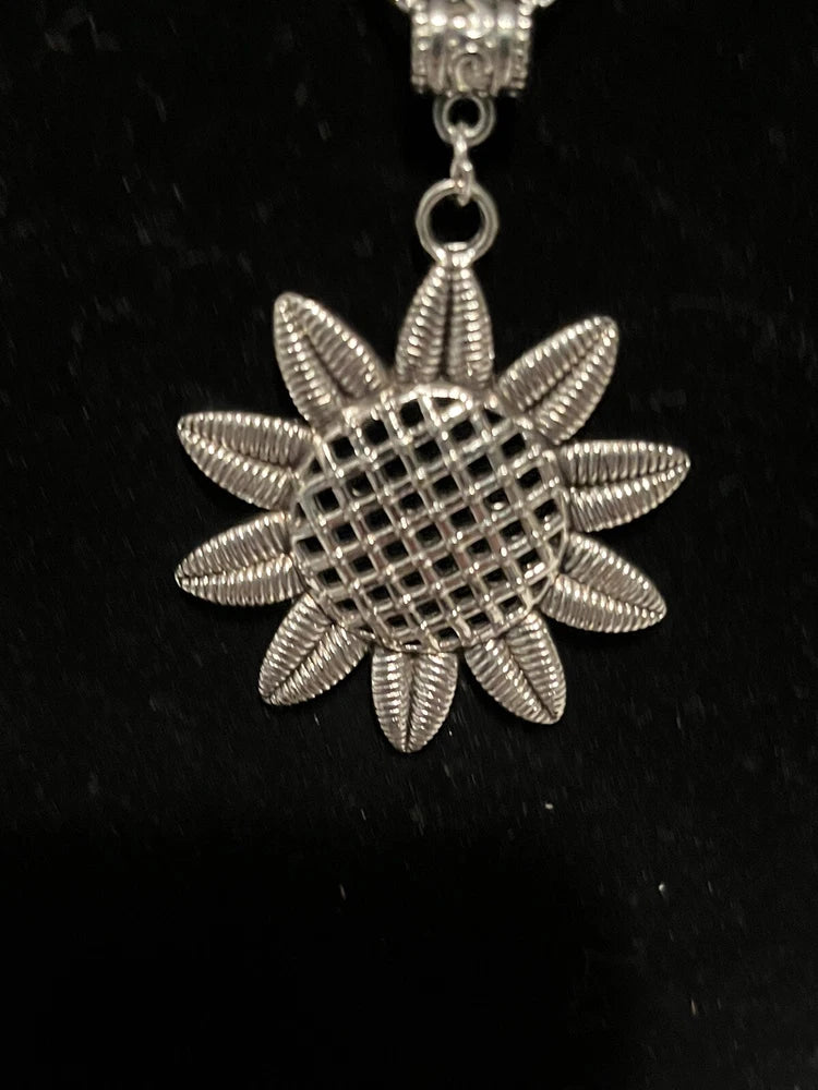 Silver-tone sunflower pendant necklace with textured petal design on a short chain