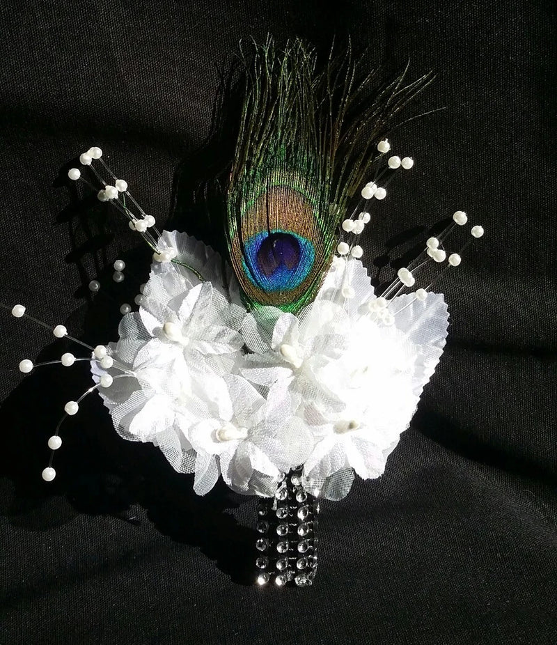 White peacock-feather boutonniere with ruffled flower and beaded accents