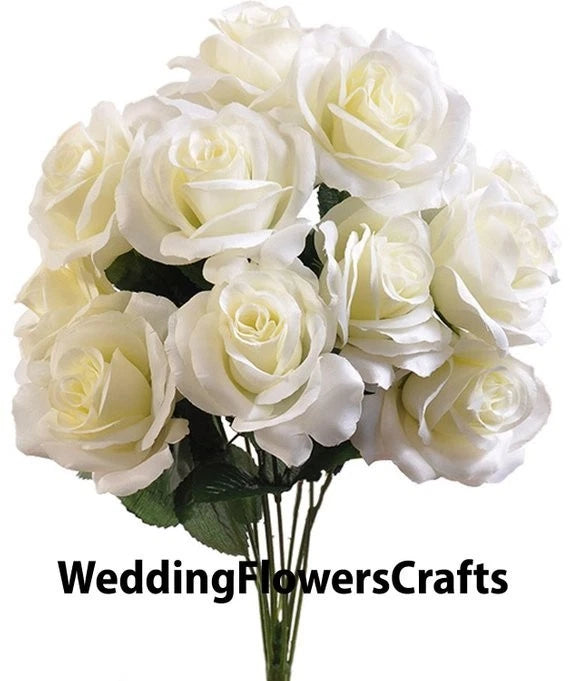 Artificial faux rose bouquet with open ivory blooms and dark green leaves
