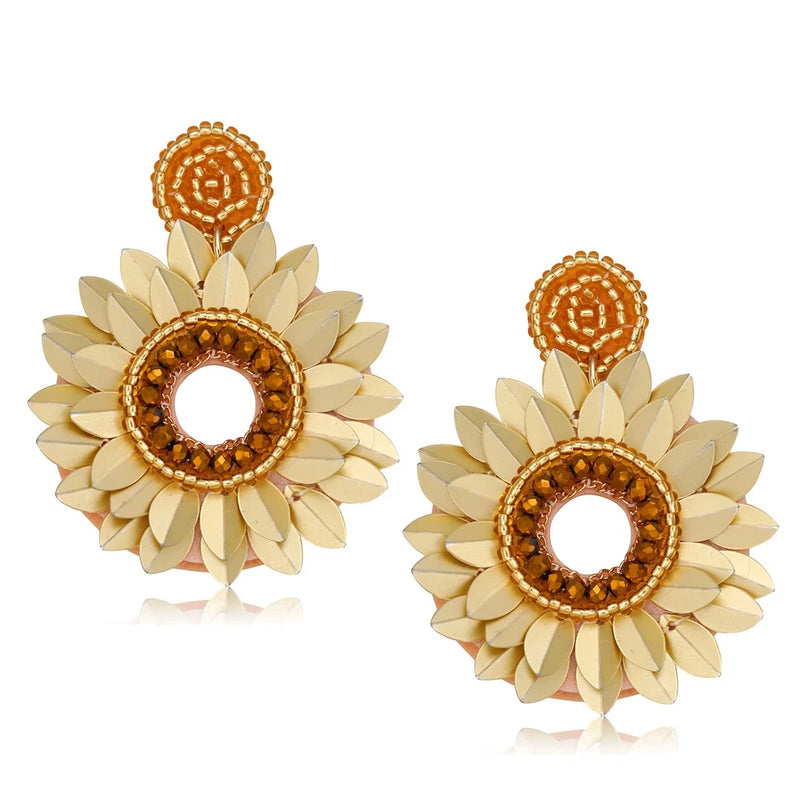 Beaded sunflower statement earrings with cream petals and gold beaded centers, dangling hoops