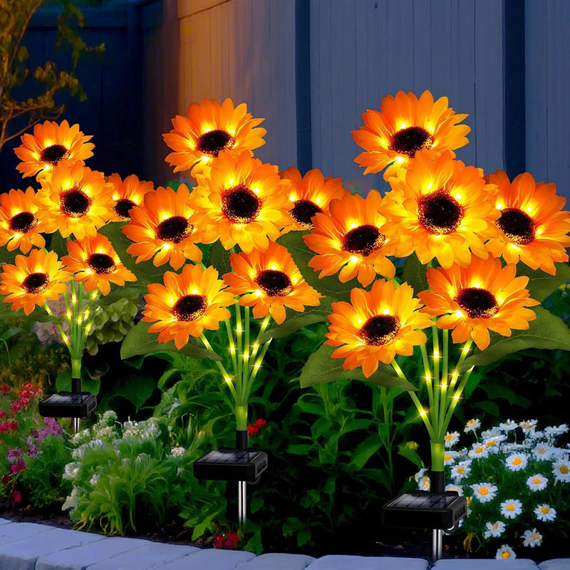 Solar sunflower garden lights set of three with glowing orange flowers and black stakes
