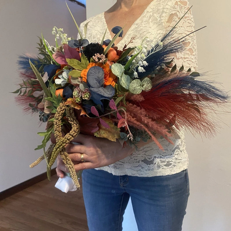 Handmade faux flower wedding bouquet with rainbow blooms and long feather accents