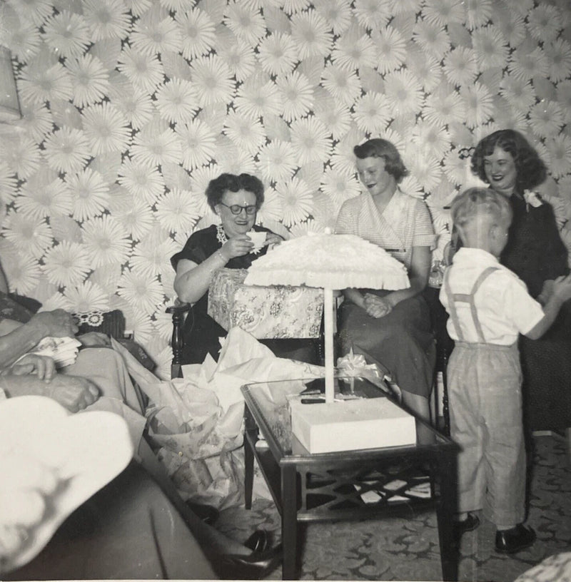 Vintage sunflower wallpaper panel with black-and-white family gift-opening scene