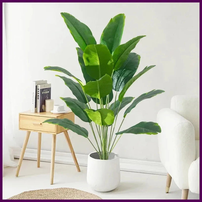 Large artificial tropical palm plant with green leaves in white pot