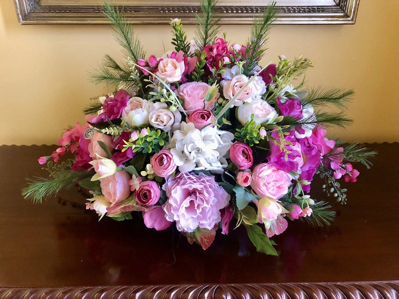 Pink and white floral bouquet with peony-like blooms, roses, and green foliage