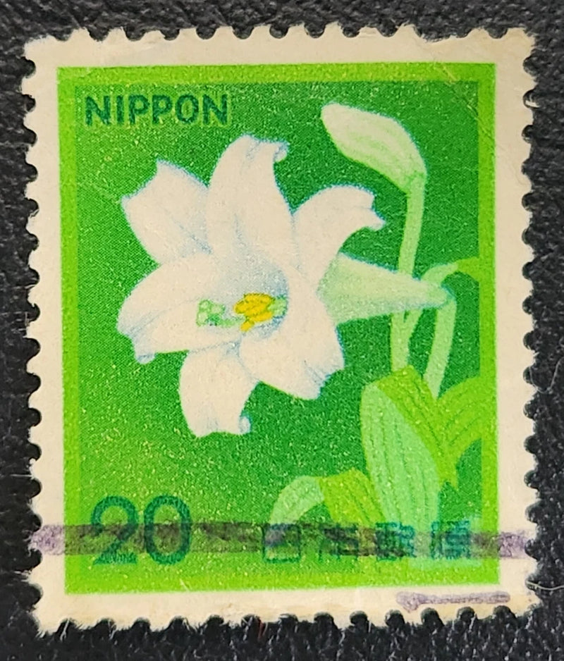 Japan postage stamp: white trumpet lily on green with NIPPON and 20