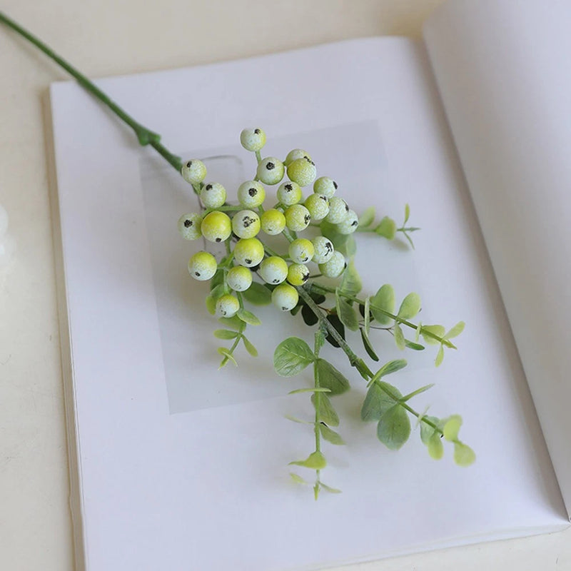 Artificial berry flower stem with light green faux berries and small green leaves