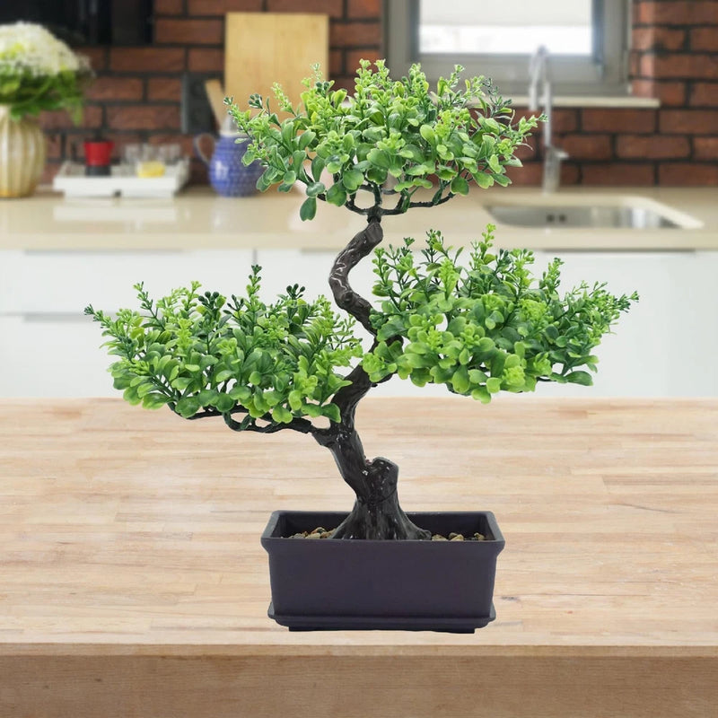 Artificial bonsai tree centerpiece in dark rectangular planter with dense green foliage