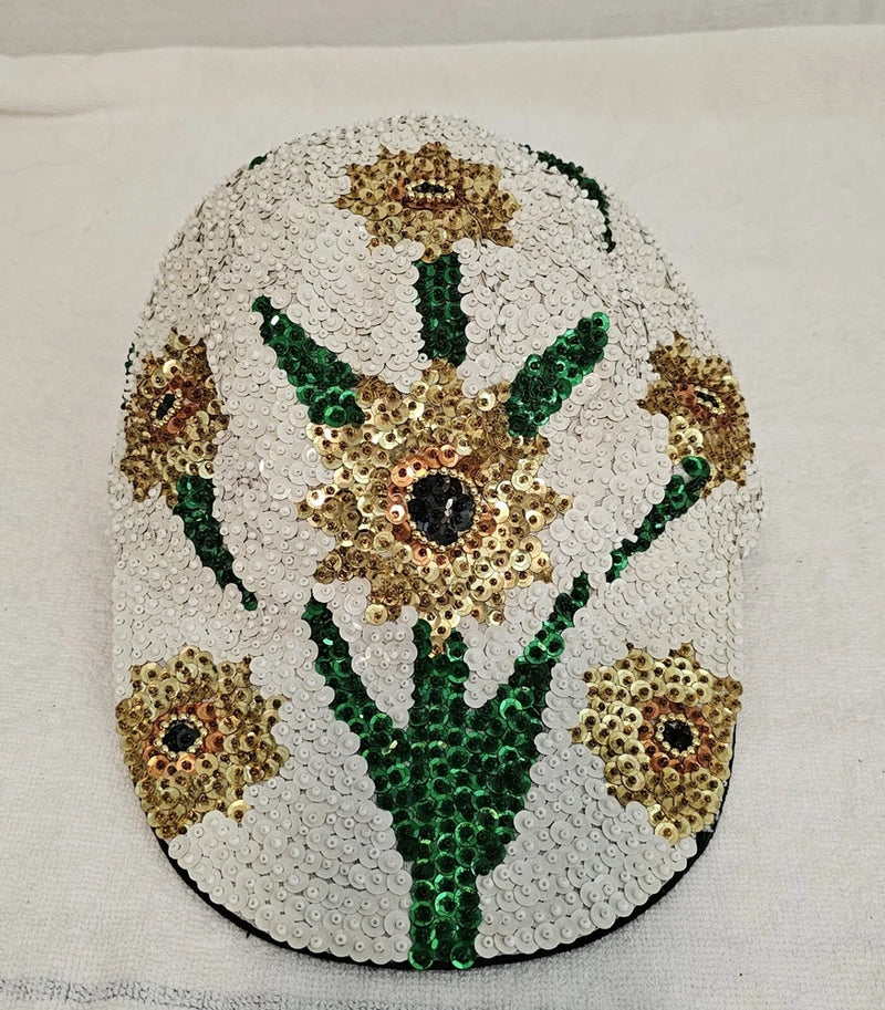 Sequin sunflower ball cap with gold and green floral detailing on white fabric