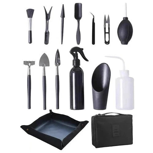 Black garden transplanting tool set with tools, mat, spray bottle, and storage bag