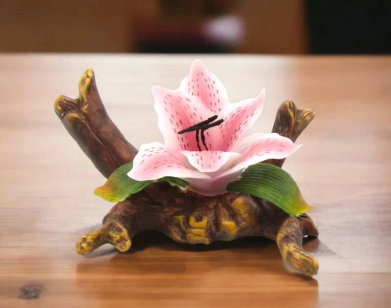 Ceramic tiger lily flower figurine with pink petals and green leaves on brown base