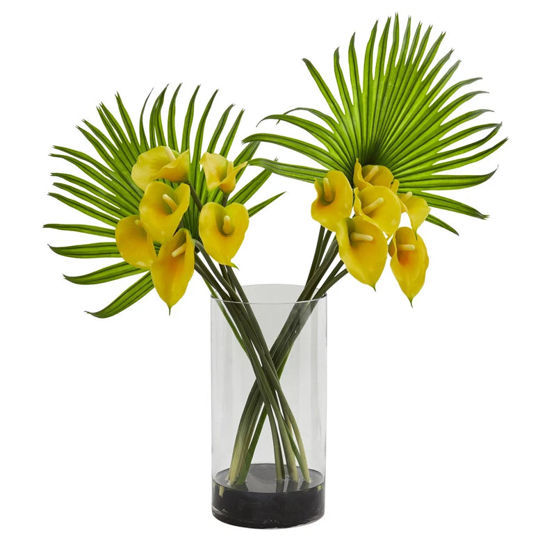Artificial yellow calla lily and fan palm arrangement in clear glass cylinder