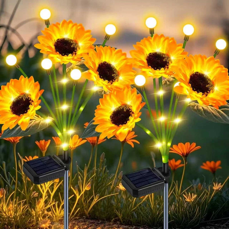 Solar sunflower LED garden lights, glowing bulbs on two stake lamps with green stems