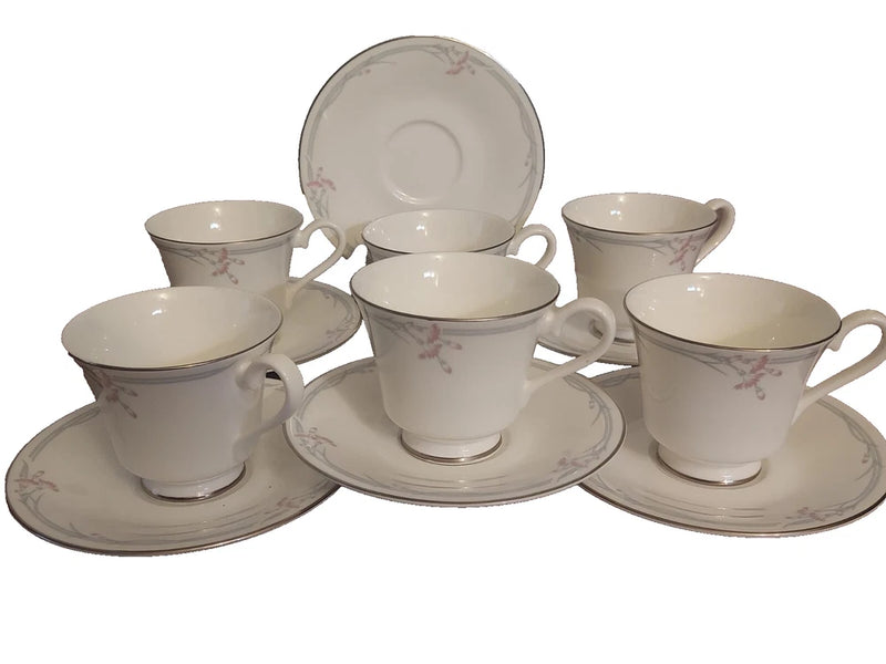 Bone china cup and saucer set with pale pink floral pattern, 6-piece arrangement