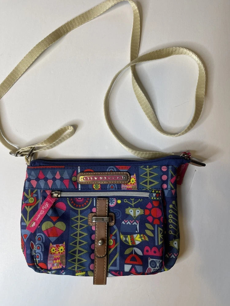 Colorful geometric-print crossbody purse with zipper and brown front pocket detail