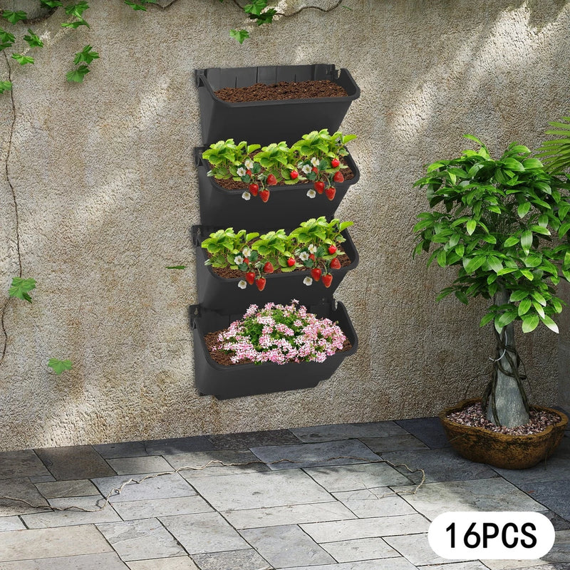 Black wall-mounted vertical planter with stacked pockets for flowers and herbs