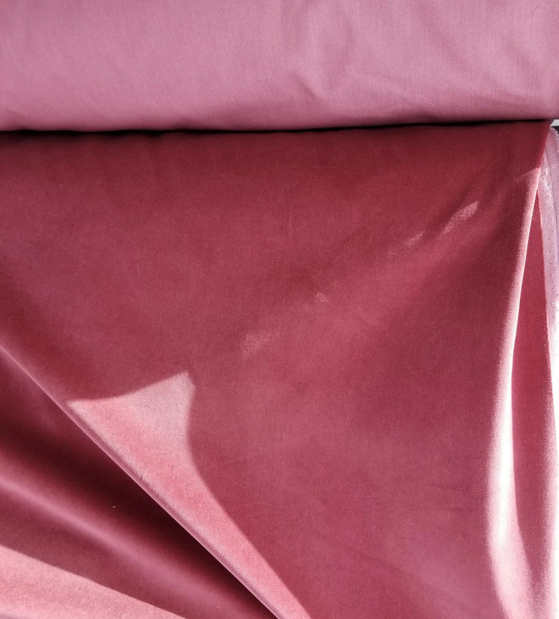 Dusty rose velvet cotton fabric with smooth folded texture