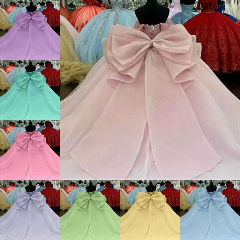 Light pink tulle bow with layered loops and long hanging tails for quinceanera dress