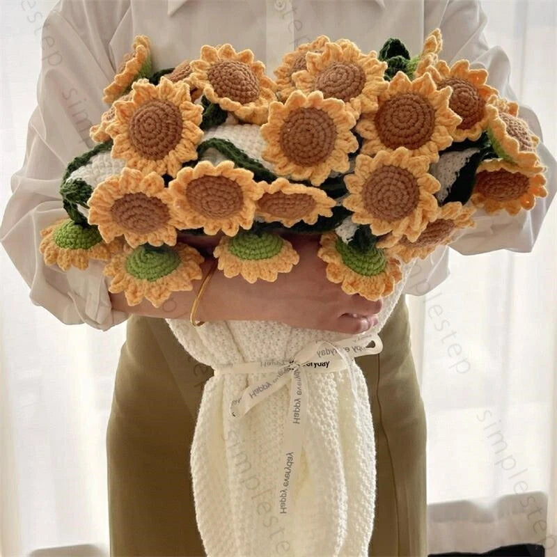 Crochet sunflower bouquet throw blanket with large crocheted blooms and green leaves