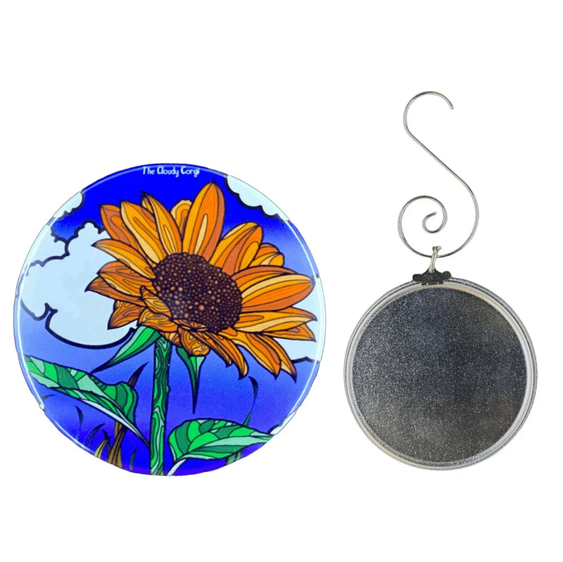 Round sunflower holiday ornament with colorful art and metal hanging hooks