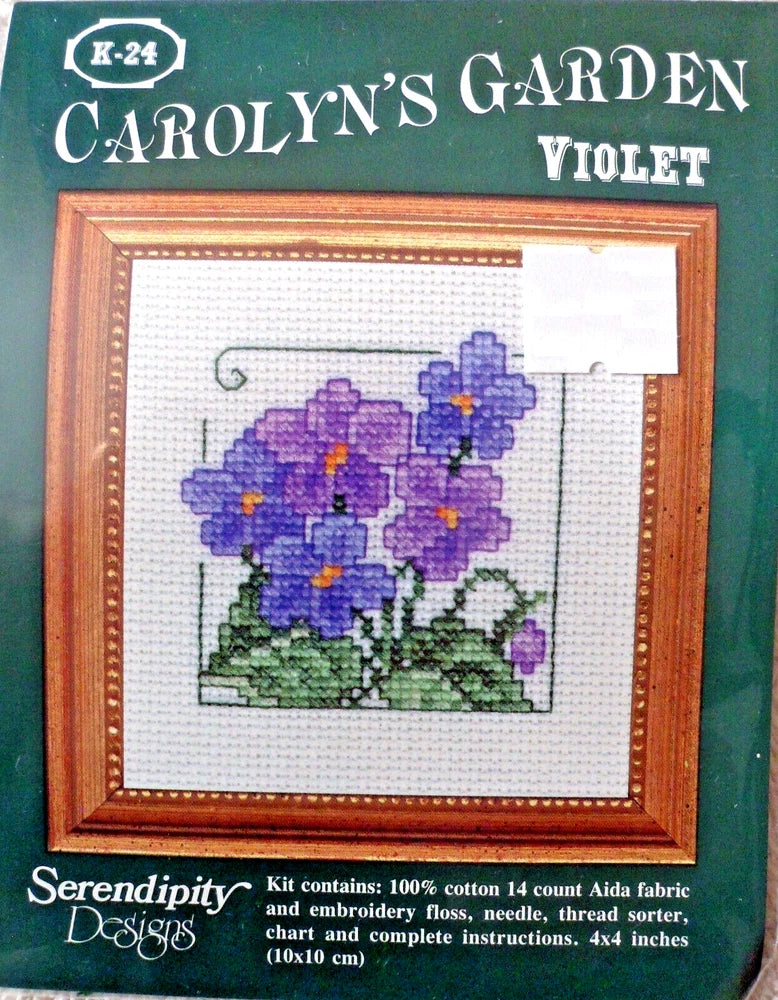 Framed cross-stitch kit with purple flower pattern on white fabric