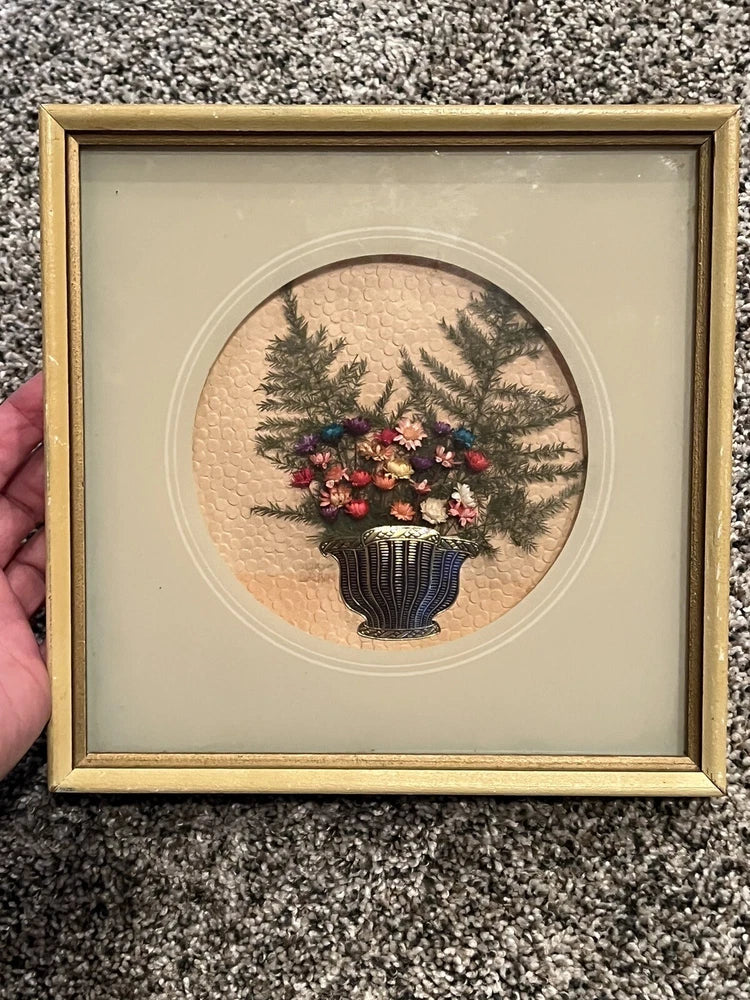 Framed dried flower wall art under glass with pine sprigs and red blooms in vase, wood frame