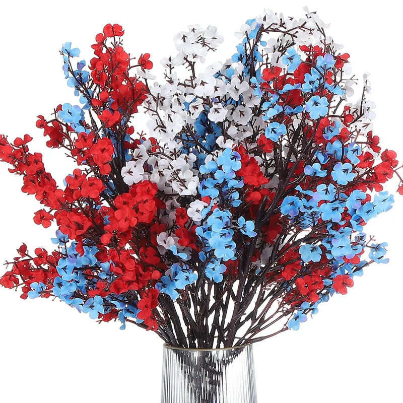 Artificial flower bouquet with red, blue, and white blossoms on brown stems in vase